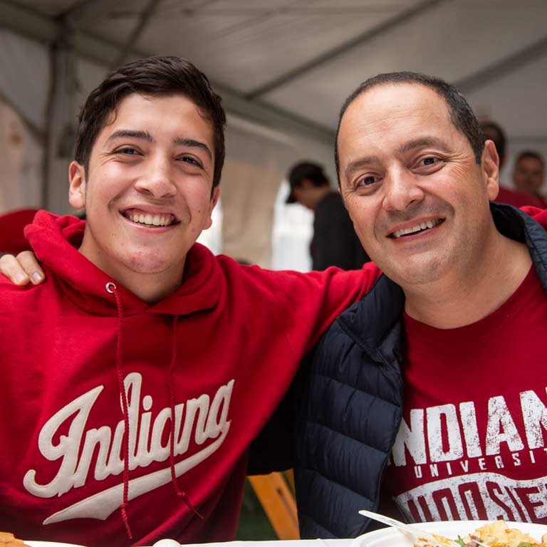 a father and son smiling, wearing Indiana University shirts